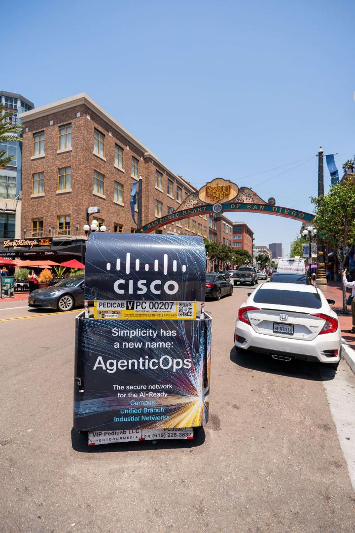 Rear of a Cisco AgenticOps wrapped pedicab under the Gaslamp Quarter arch